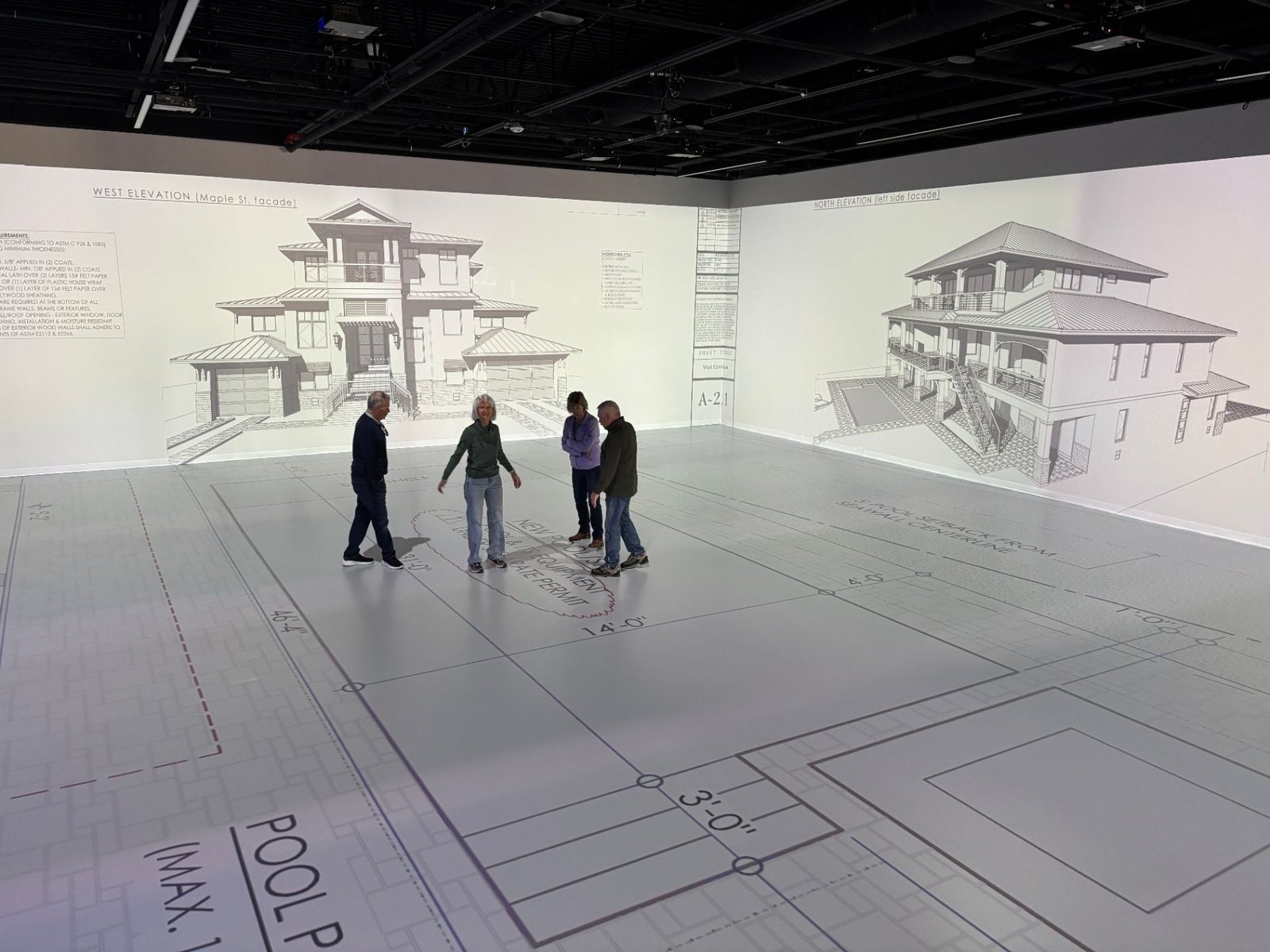 Full-scale plans projected across the studio floor and walls